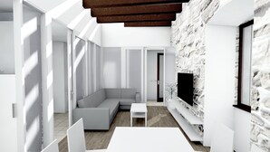 A modern living room with a stone accent wall, a grey sofa, and a flat-screen TV mounted on the wall.