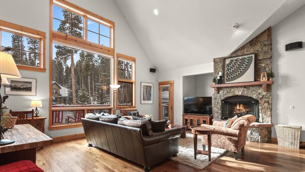 A spacious living room with a fireplace, large windows, and a cozy seating area. - Peak 10 Place - Free Winter Shuttle to Lift - Ski-In, Ski-Out for Experts Only (Breckenridge)