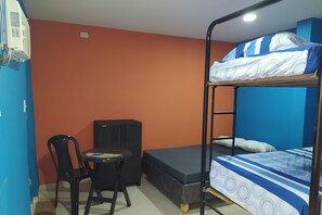 Cozy retreat with a bunk bed, desk, and chair, perfect for a comfortable stay.