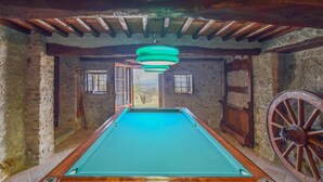 A pool table in a rustic room with stone walls and wooden beams. - 4 bedroom cozy home in Camaiore (Camaiore)