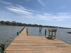 A wooden pier extending into calm water, with a bench on the right side. - Sunny San Leon Casita!! (San Leon)