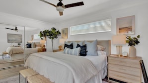 A bedroom with a large bed, bedside tables, a ceiling fan, and a mirror. - Level up your Old Town stay- Walk to bars- 2 Kings (Scottsdale)