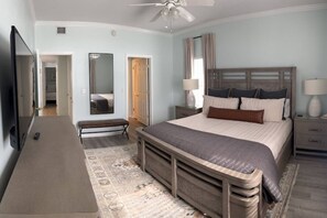 A bedroom with a bed, bedside tables, a mirror, a ceiling fan, and a TV. - Right ON world’s whitest beach, Pensacola Beach, Florida. (Pensacola Beach)