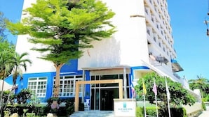 A tall, white building with the sign "HUA HIN BLUEWAVE" at the top.