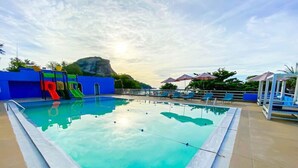 A rectangular swimming pool with a clear blue water surface, surrounded by a tiled deck.
