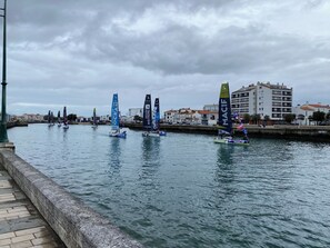 A waterfront with sailboats, a stone walkway, and buildings in the background. - La Chaume, Typical and charming fisherman's house (Les Sables-d'Olonne)
