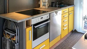 A compact kitchen with a built-in dishwasher, oven, and coffee maker. - 1 bedroom lovely home in Ueckermuende (Ueckermuende)
