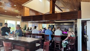 A bar area with wooden ceiling and bar stools, surrounded by patrons. - 2BR - Key Largo Sunshine Getaway (Tavernier)