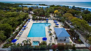 An aerial view of a resort with a large pool, lounge chairs, and a beach area. - 2BR - Key Largo Sunshine Getaway (Tavernier)