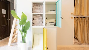 A room with a white wardrobe, a potted plant, and a ladder. - Swwitch House Central Tokyo 7 (Tokyo)