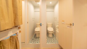 A bathroom with two toilets, a shower curtain, and a patterned floor. - Swwitch House Central Tokyo 7 (Tokyo)