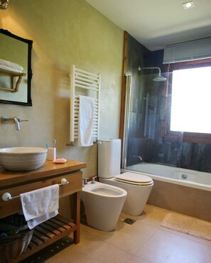 A bathroom with a large sink, toilet, and bathtub.