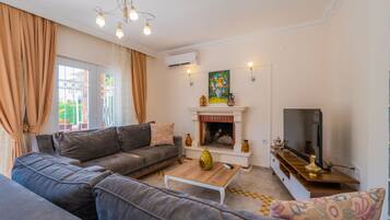 Deluxe Villa | Living area | LCD TV, fireplace