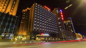 A large, illuminated hotel with a prominent 'Hampton' sign, multiple floors, and a well-lit facade. - Hampton by Hilton Lanzhou Mogao Avenue (Lanzhou)