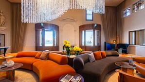A spacious living area with two large sofas, a coffee table, and a decorative chandelier. - Ca' di Dio - VRetreats, SLH Collection (Venice)