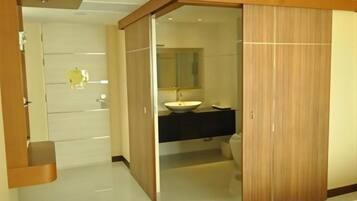 A modern bathroom with a wooden vanity, a sink, and a mirror.