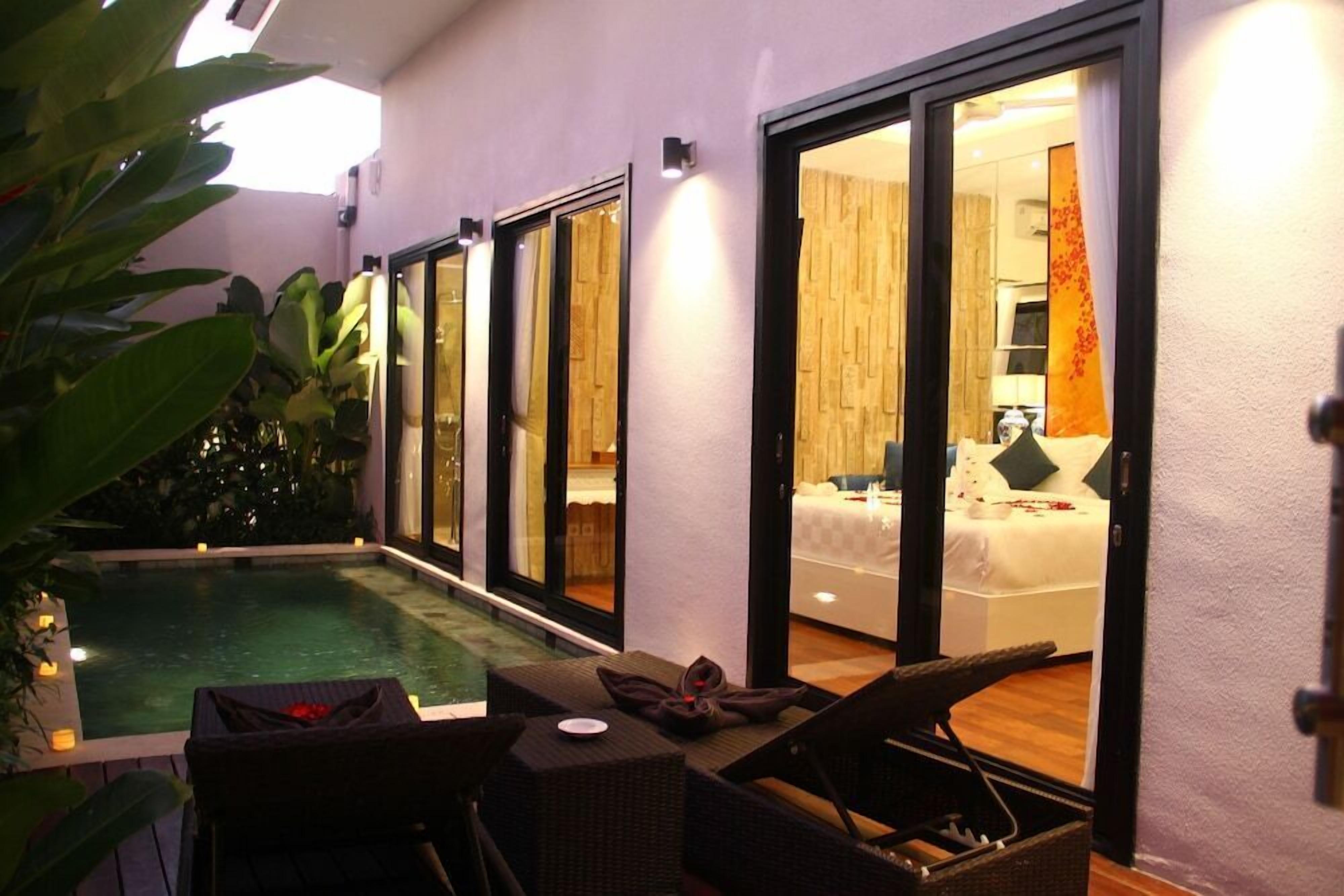 A private pool area with a glass-enclosed bedroom visible through the glass doors.