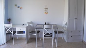 A room with a white desk, two chairs, a cabinet, and a small hanging decoration. - Leela Apartment,  ideal for romantic gateway! (Dubrovnik)