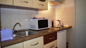 A compact kitchen with a microwave, sink, and a small refrigerator. - Leela Apartment,  ideal for romantic gateway! (Dubrovnik)
