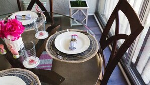 A dining table set with plates, glasses, and a centerpiece. - Immaculate Fort Myers Condo, ideal location-quiet (Fort Myers)