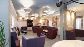 A modern interior with seating areas, a flat-screen TV, and artwork on the walls. - B&B Hotel Berlin-Alexanderplatz (Berlin)