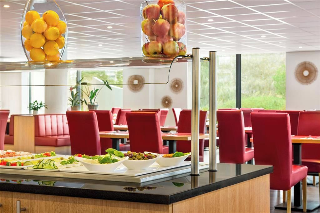 A buffet setup with various food items and a modern interior design.