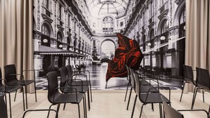 A spacious room with a large mural of a historic building, modern black chairs, and a large red and black abstract sculpture. - Amedia Milano - Trademark Collection by Wyndham (Milan)