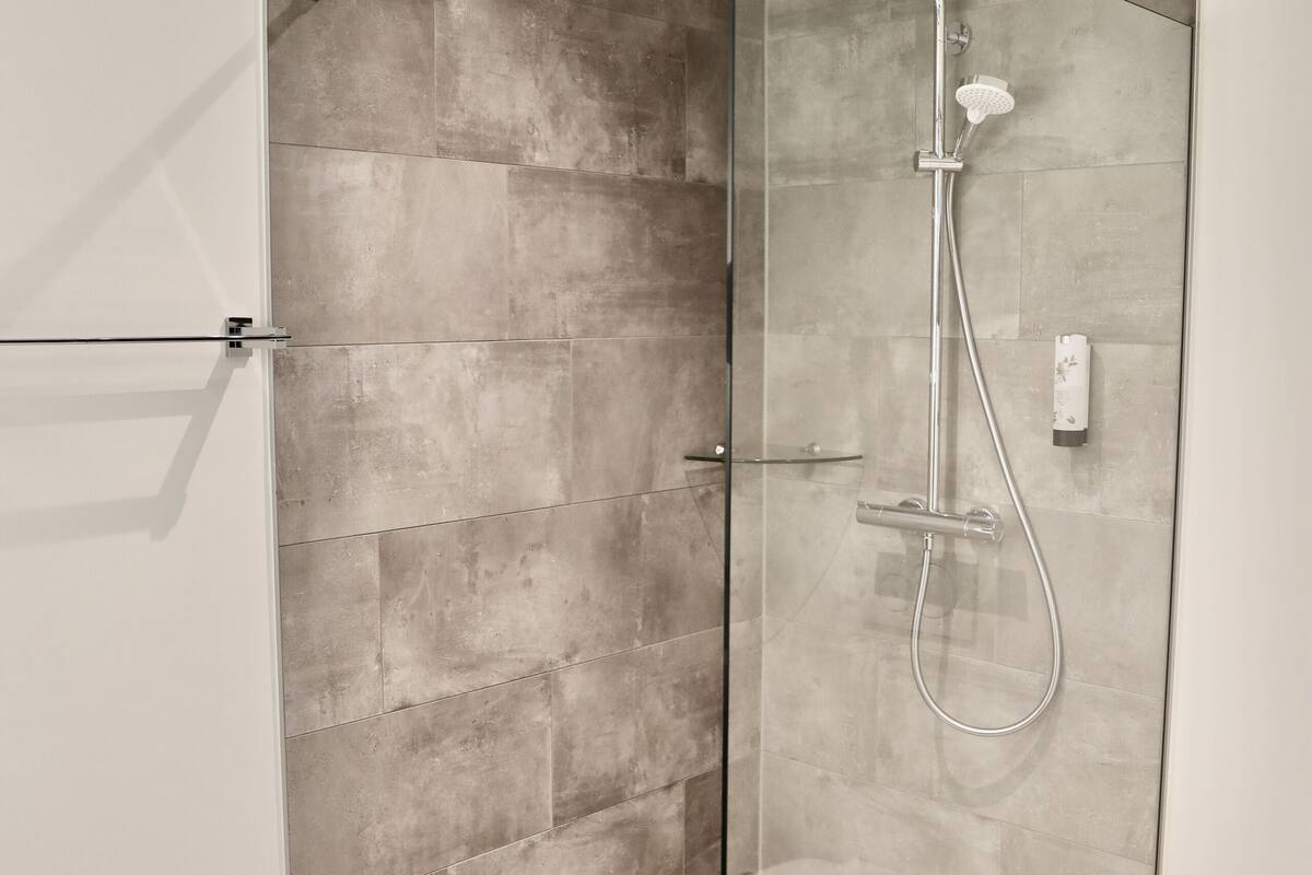 shower, rainfall showerhead, hair dryer, slippers