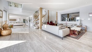 A spacious living area with a modern staircase, a large window, and a minimalist design. - Luxury Seafront Villa Dubrovnik Lux Life with Pool (Dubrovnik)