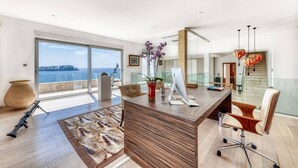 A modern office with a large desk, a computer, and a view of the sea. - Luxury Seafront Villa Dubrovnik Lux Life with Pool (Dubrovnik)