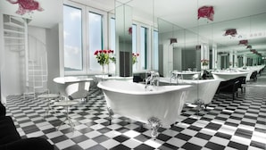 A modern bathroom with a checkered floor, a freestanding bathtub, and multiple sinks. - Luxury Villa Castello Dubrovnik with Pool & Sauna (Dubrovnik)
