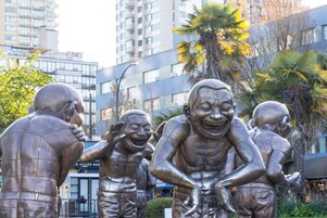 A sculpture of muscular figures in a public space.