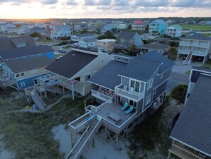 A coastal residential area with houses featuring balconies and decks, some with attached porches. - Tropic like Its Hot Oak Island Oceanfront House, Tropic Like Its Hot Oak Island- Beach Front (Oak Island)