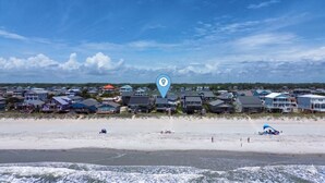 A beachfront residential area with houses, a sandy beach, and ocean waves. - Tropic like Its Hot Oak Island Oceanfront House, Tropic Like Its Hot Oak Island- Beach Front (Oak Island)