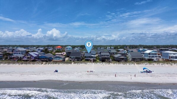 A beachfront residential area with houses, a sandy beach, and ocean waves. - Tropic like Its Hot Oak Island Oceanfront House, Tropic Like Its Hot Oak Island- Beach Front (Oak Island)