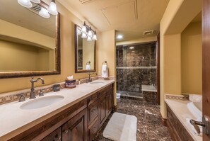 A bathroom with two sinks, a large mirror, and a shower area. - Silver Strike by Luxury Mountain Destina (Park City)