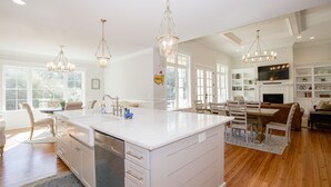 A spacious kitchen with a large island, white cabinetry, and pendant lighting. - 600 Linden: 8  BR, 5.5  BA House in Pinehurst, Sleeps 20 (Pinehurst)
