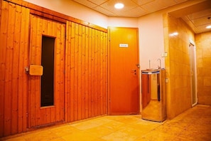 A hotel corridor with wooden doors, a private room sign, and a glass elevator. - Mamad Deluxe 2BR Apt w Pool in Historical Jaffa (Tel Aviv-Yafo)