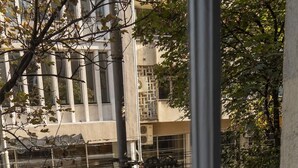 A view from a window overlooking a building with a modern architectural style, featuring large windows and a visible balcony. - Kings Palace Suites (Belgrade)