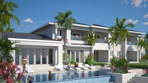 A modern resort with a large swimming pool, multiple lounge areas, and a well-maintained garden with palm trees. - A beautiful private beachfront paradise in Old Fort Bay, Ocho Rios (St. Ann Parish)