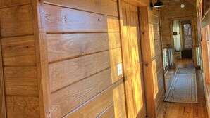 A wooden interior hallway with a wooden floor, a light fixture, and a door leading to another room. - Majestic Views, Romantic Brow Home 1.5 Miles From The Heart Of Mentone (Mentone)