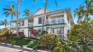 A two-story hotel with a balcony on the second floor, surrounded by tropical vegetation. - Regency at Poipu Kai #621 By Parrish Kauai - premier condo with central air grea (Koloa)