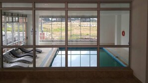 A room with a large window overlooking a swimming pool and a grassy area. - WOW! NEW 3/2BR, NEAR AIRPORT & SHOPPING - PREMIUM! (Bogotá)