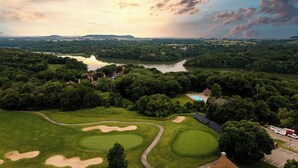 A golf course with a pond, surrounded by dense trees and a small building with a pool. - 2 Bedroom +Loft, 2 bath townhouse in The Galena Territory (Galena)