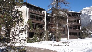 A multi-story building with balconies, surrounded by snow and trees. - Am Dürrbach 5/545 Appartement/Fewo 4-Bettwohnung by Interhome (Engelberg)