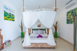 A bed with a canopy, a green plant, and a painting on the wall.