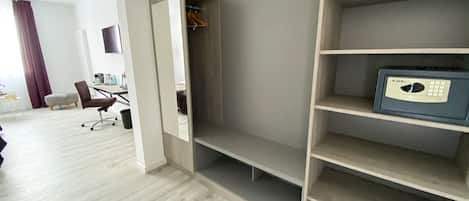 A modern room with a built-in wardrobe, a desk, and a chair.