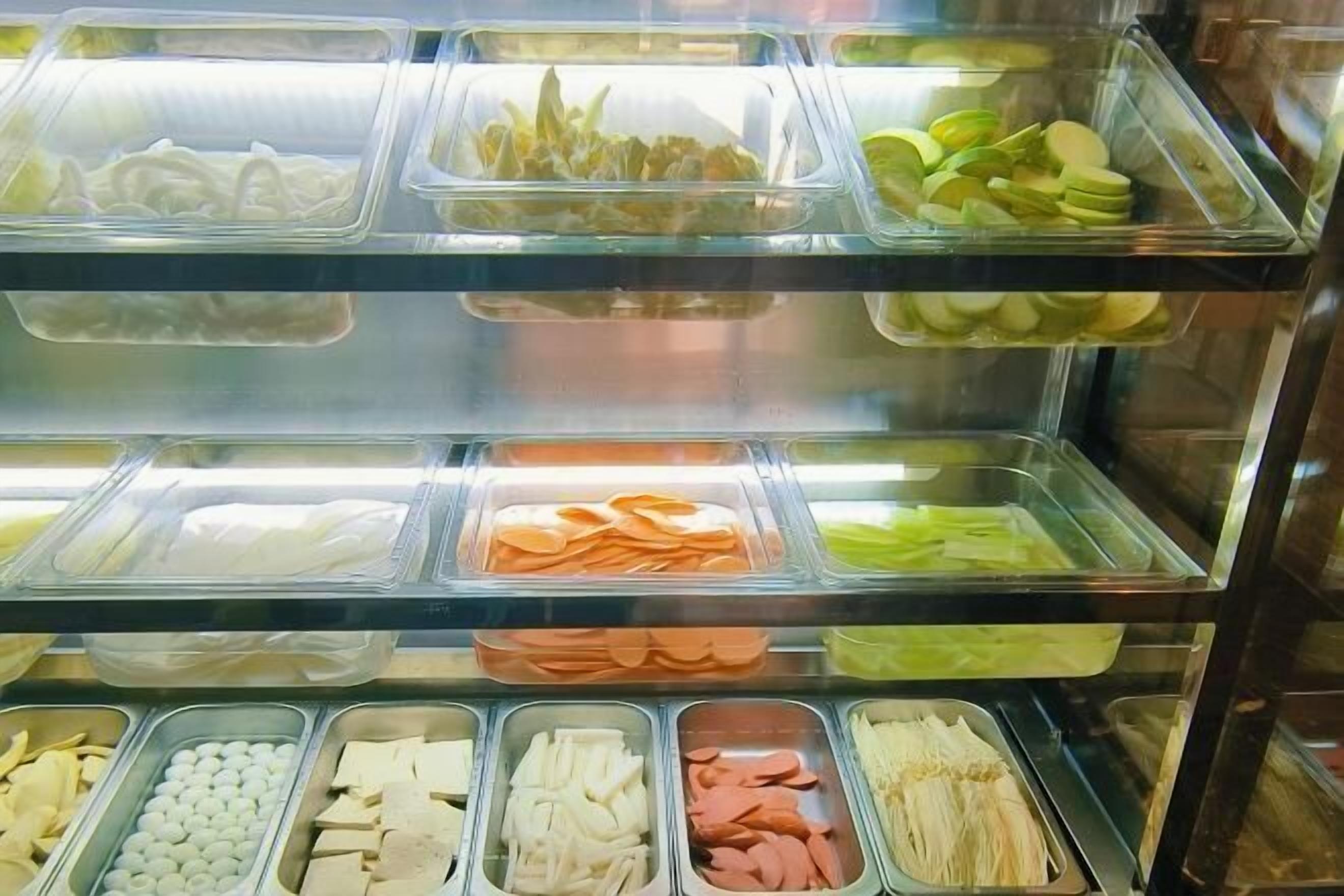 A food display case with various food items.