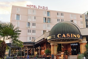 A hotel with a casino, featuring a large sign for the casino and a prominent "HOTEL PARIS" sign above the building. - Paris (Opatija)