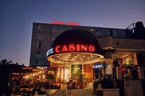 A hotel with a prominent casino sign and a "HOTEL PARIS" sign above. - Paris (Opatija)